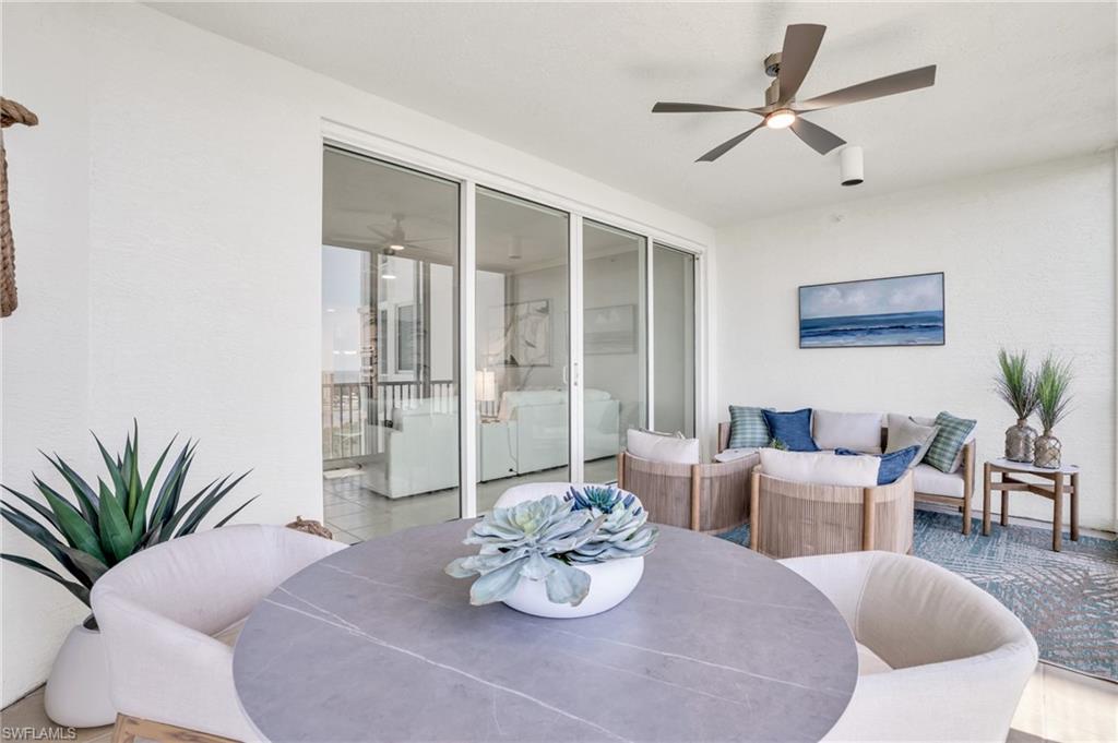 265 Indies Way, Unit 1404 Naples, FL 34110 - Photo 32 of 43 a living room with furniture potted plant and a window