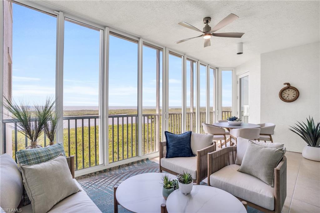 265 Indies Way, Unit 1404 Naples, FL 34110 - Photo 33 of 42 a living room with furniture and a large window