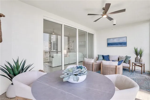 a living room with furniture potted plant and a window