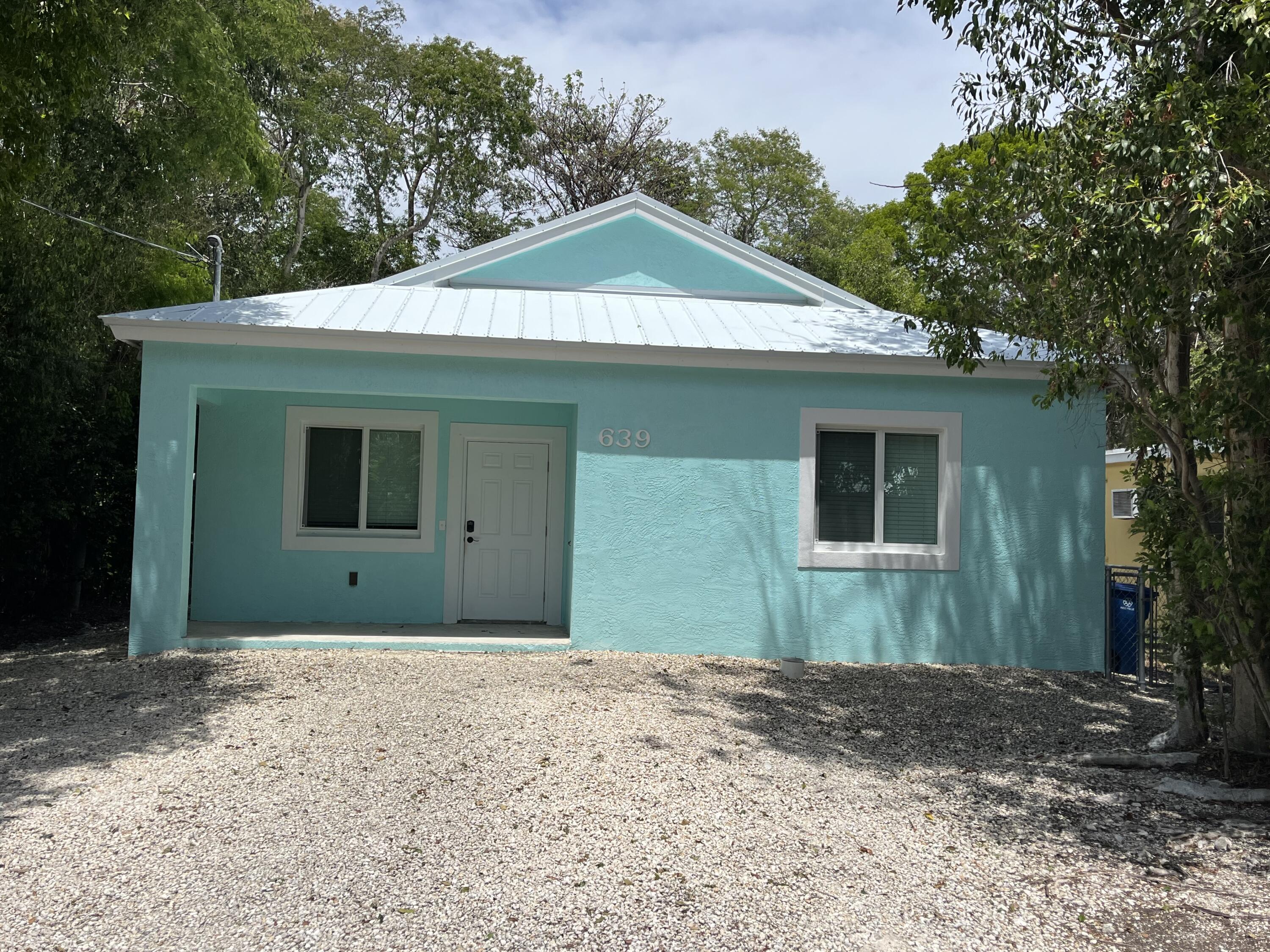 639 Cabrera Street Key Largo, FL 33037 - Photo 2 of 24 a front view of a house with garden