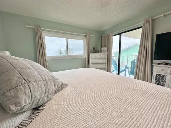 a bedroom with a bed and a large window with outer view