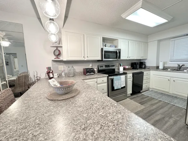 a kitchen with a refrigerator stove and sink