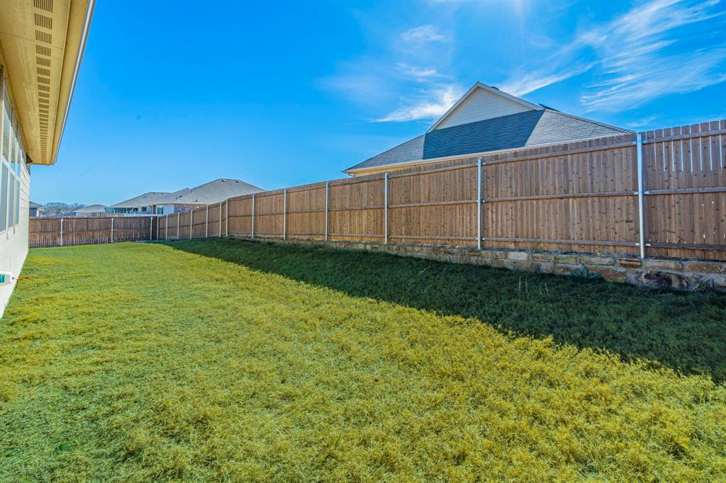 1240 Almond Road Azle, TX 76020 - Photo 20 of 26 a view of a backyard with a small cabin