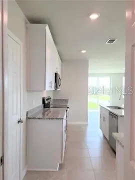 a view of living room with granite countertop furniture and fireplace
