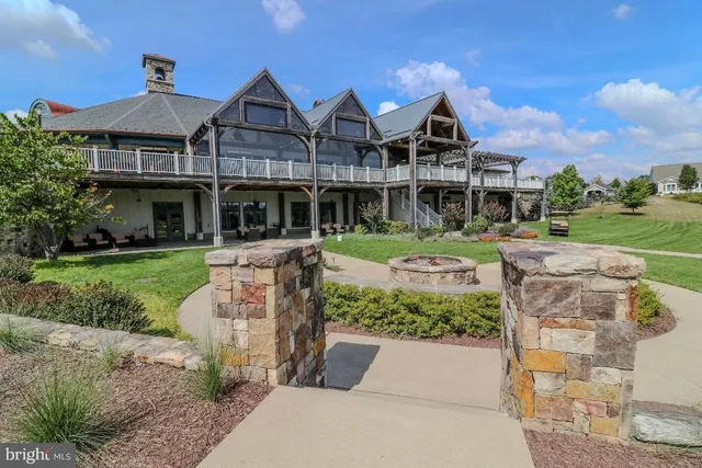 a front view of house with swimming pool and seating