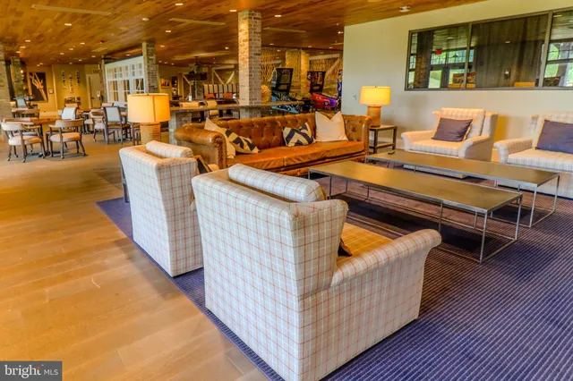 a living room with furniture wooden floor and a flat screen tv