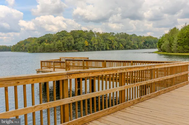 a kitchen with stainless steel appliances granite countertop a sink a oven and a large window