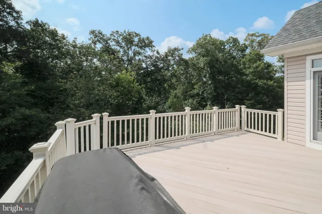 a bedroom with a bed and a ceiling fan
