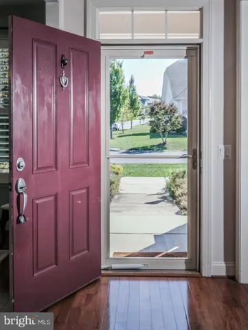 a bathroom with a granite countertop toilet sink and mirror