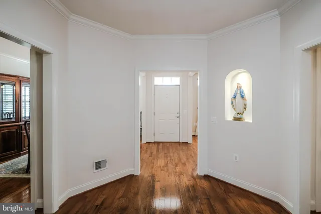 a living room with game table and a wooden floor