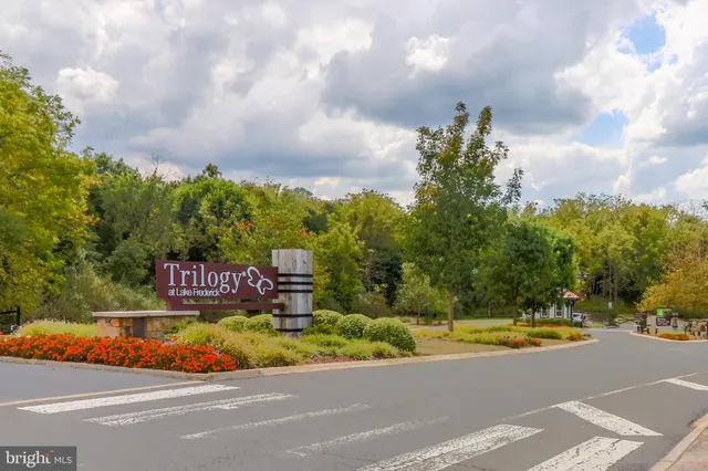 a dining table with stainless steel appliances kitchen island granite countertop a dining table chairs and a refrigerator