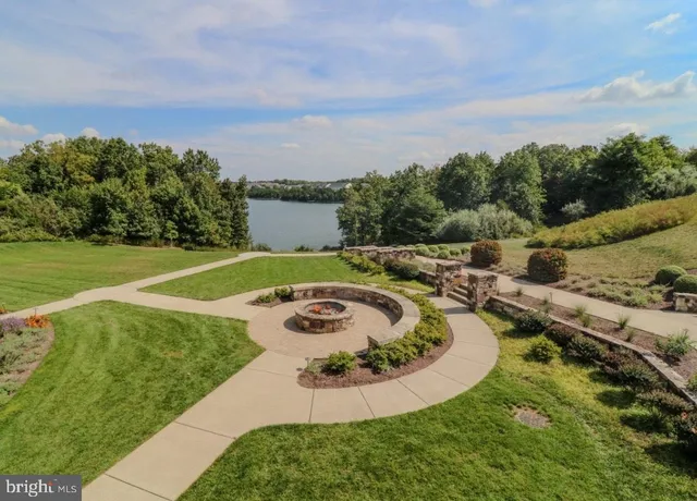 a front view of house with swimming pool and seating