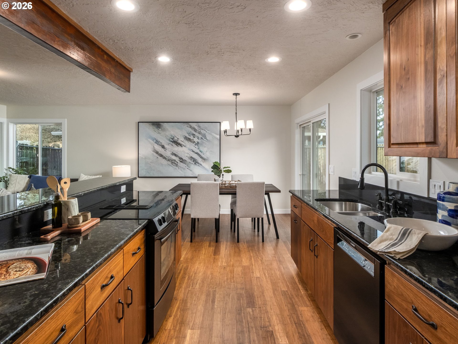 850 Northeast 179th Avenue Portland, OR 97230 - Photo 15 of 30 a kitchen with kitchen island granite countertop a sink stove and cabinets