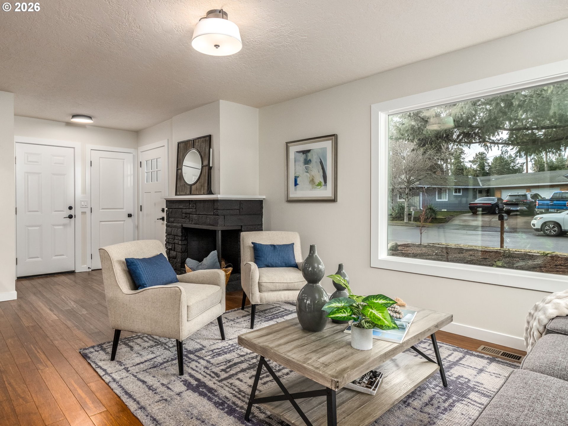 850 Northeast 179th Avenue Portland, OR 97230 - Photo 9 of 30 a living room with furniture a large window and a fireplace