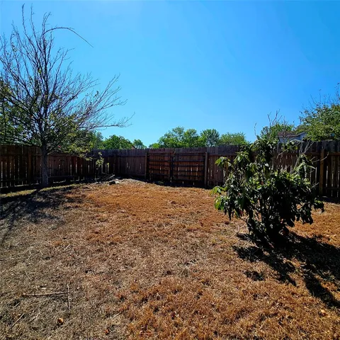 a front view of a house with a tree