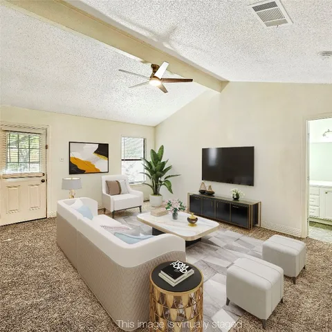 a view of an empty room with a window and fireplace