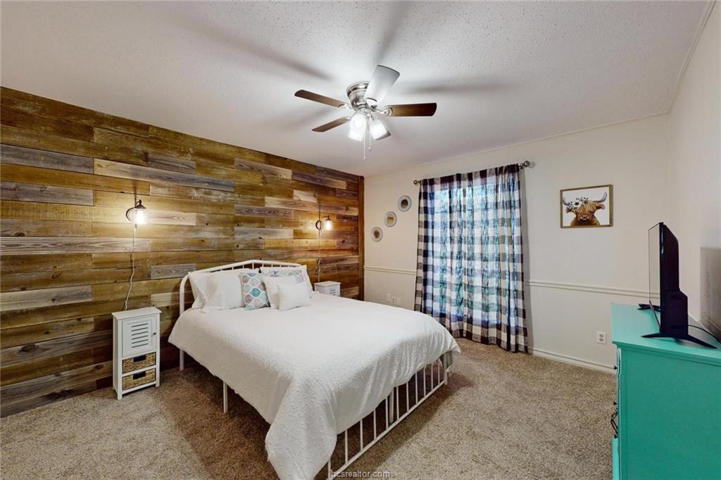 900 Westview Street Bryan, TX 77802 - Photo 19 of 30 a bedroom with a bed and a flat screen tv