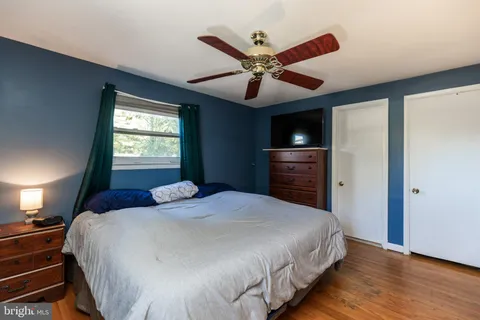 a bedroom with a large bed and a tv