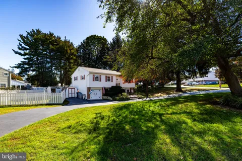 a view of a house with swimming pool and sitting area
