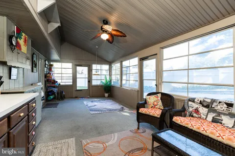 a living room with furniture fireplace and a large window