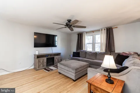 a living room with furniture flat screen tv and a fireplace