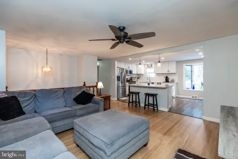 a living room with furniture and kitchen view