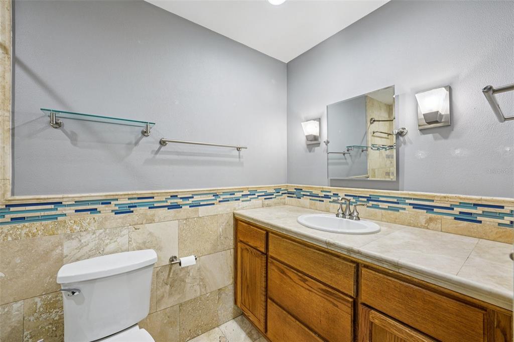 2015 Ronald Circle Seffner, FL 33584 - Photo 16 of 27 a bathroom with a granite countertop sink a mirror and a toilet