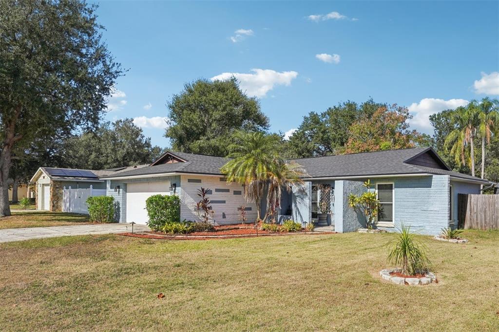 2015 Ronald Circle Seffner, FL 33584 - Photo 2 of 27 a front view of a house with a garden and tree