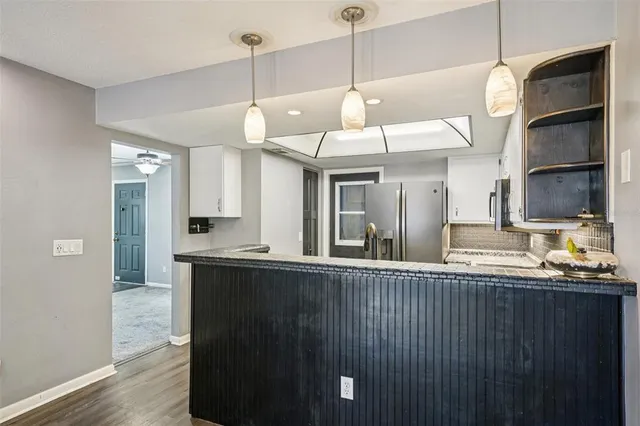 a kitchen with stainless steel appliances granite countertop counter space a sink and cabinets