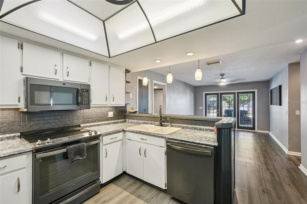 2015 Ronald Circle Seffner, FL 33584 - Photo 9 of 27 a kitchen with stainless steel appliances granite countertop a stove and a sink
