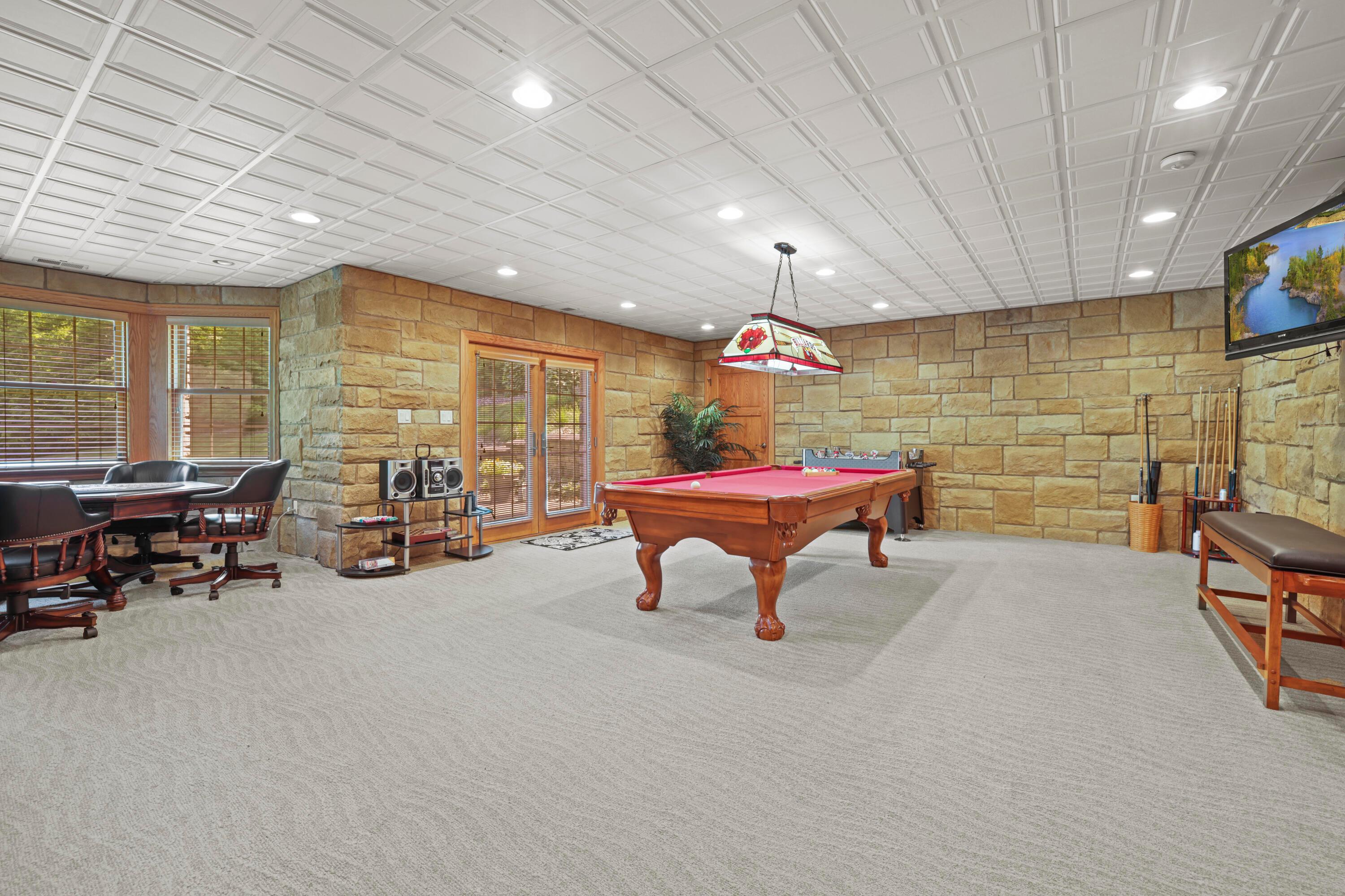 6201 Wilson Road Butler, OH 44822 - Photo 48 of 59 Billiards room with exit to concrete patio and firepit, walk-in storage space (9’4’ x 10’)