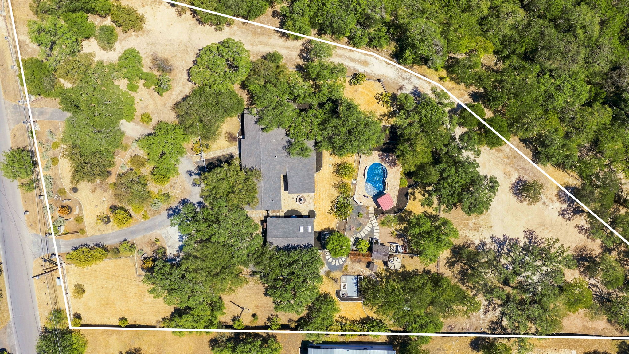 3809 Wyldwood Road Austin, TX 78739 - Photo 2 of 40 Mature trees surround this private estate featuring a swimming pool and expansive grounds.