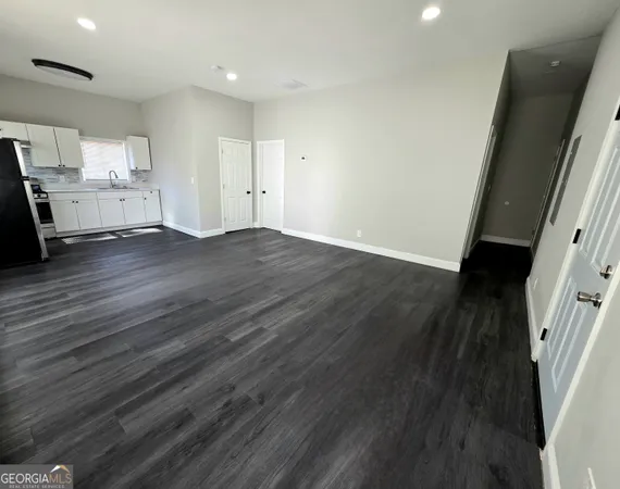 an empty room with wooden floor and a window
