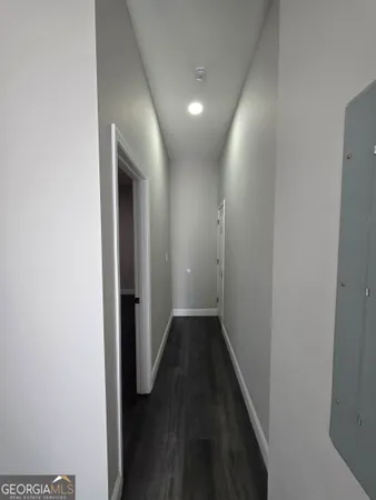 a view of hallway with wooden floor