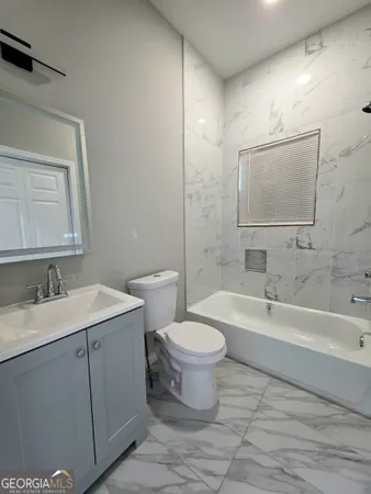 a bathroom with a toilet a sink and bathtub