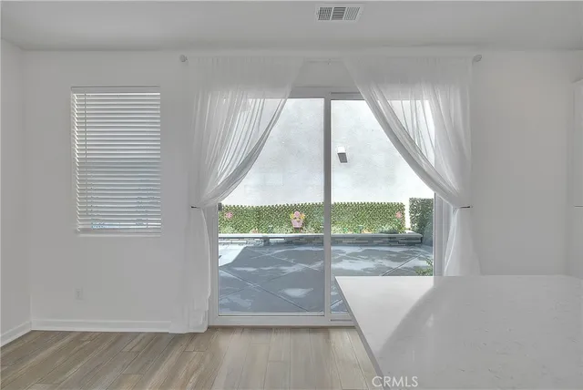 a view of a kitchen with white cabinets