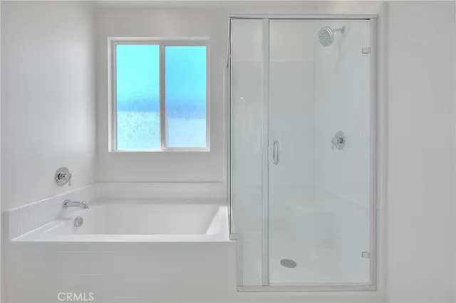 a view of a patio with couple of chairs and potted plants