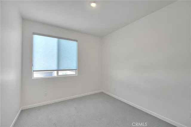 a living room with furniture and floor to ceiling windows