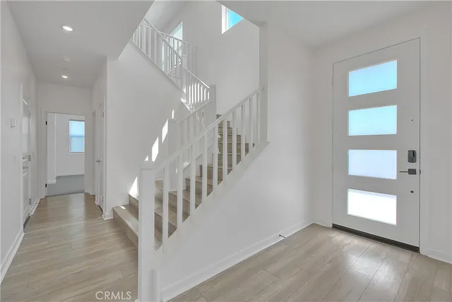 a kitchen with stainless steel appliances a stove a sink a microwave a refrigerator and cabinets