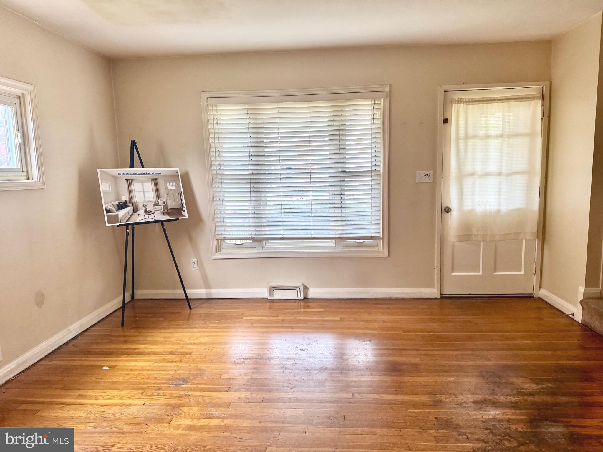 8024 Kimberly Road Dundalk, MD 21222 - Photo 3 of 16 a view of an empty room with wooden floor and a window