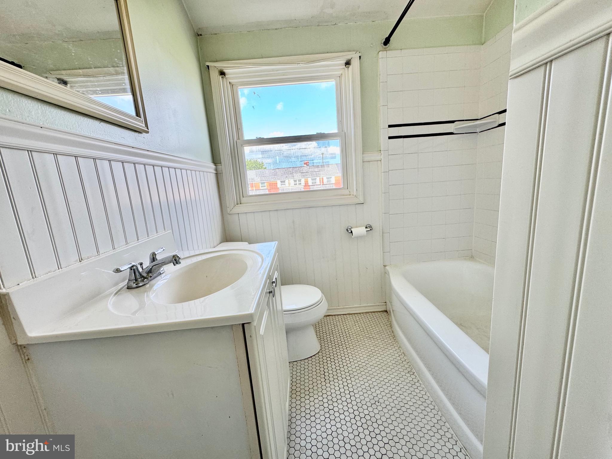 8024 Kimberly Road Dundalk, MD 21222 - Photo 7 of 16 a bathroom with a sink a toilet and shower