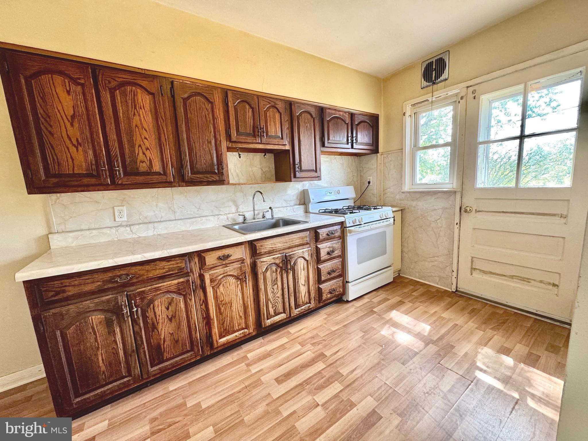 8024 Kimberly Road Dundalk, MD 21222 - Photo 9 of 16 a kitchen with a sink window and cabinets