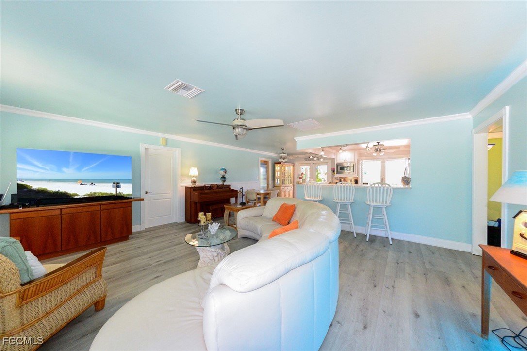 12082 Moon Shell Drive Matlacha Isles, FL 33991 - Photo 12 of 46 a living room with furniture and a wooden floor