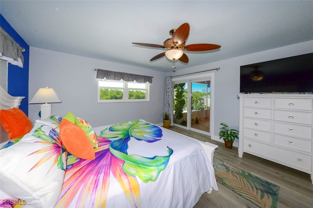 12082 Moon Shell Drive Matlacha Isles, FL 33991 - Photo 15 of 46 a bedroom with a bed and a flat screen tv