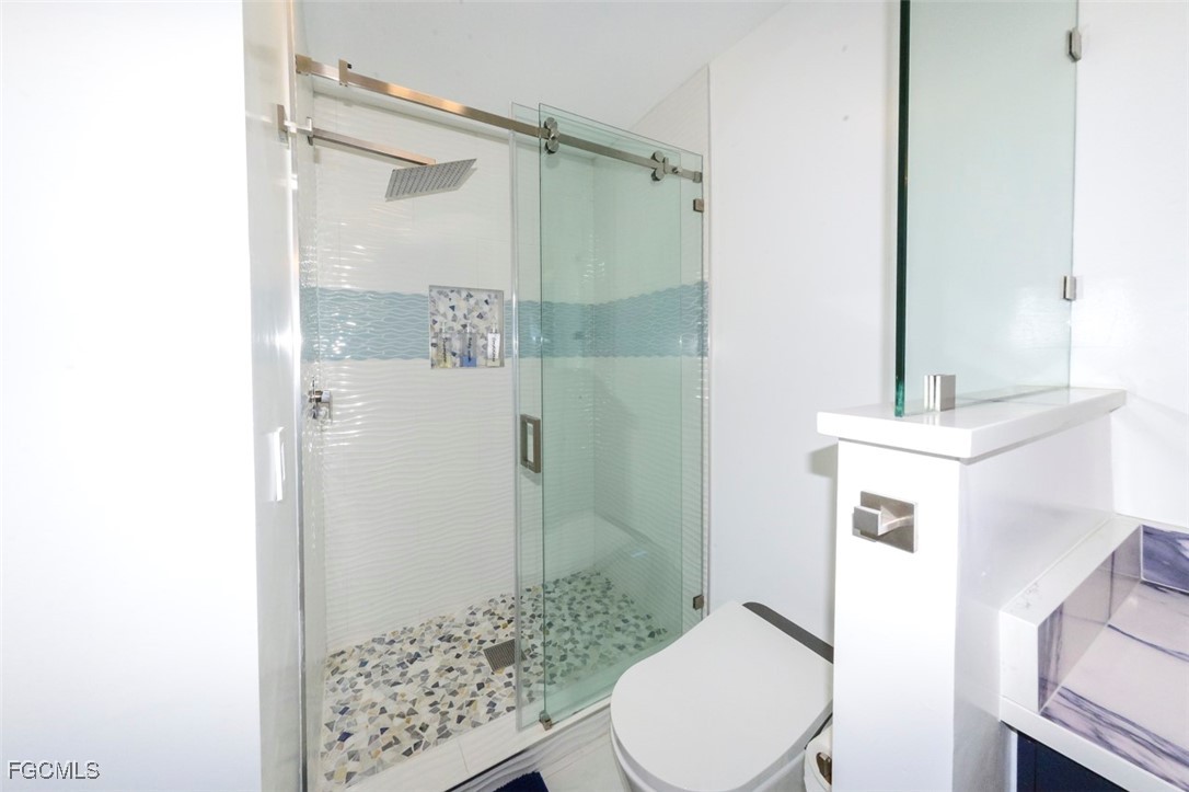 12082 Moon Shell Drive Matlacha Isles, FL 33991 - Photo 16 of 46 a bathroom with a sink a toilet and shower