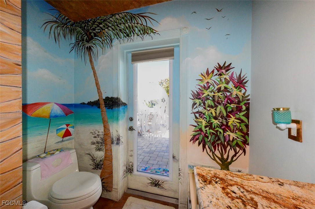 12082 Moon Shell Drive Matlacha Isles, FL 33991 - Photo 22 of 46 a potted plant sitting next to a bathroom