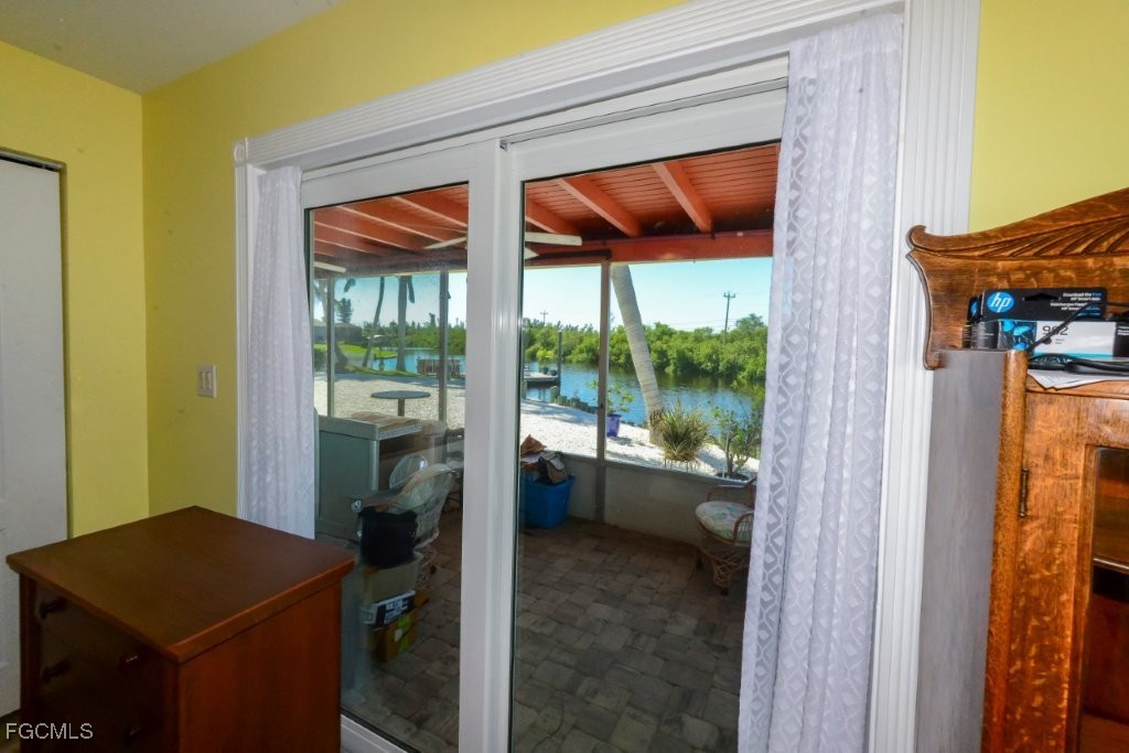 12082 Moon Shell Drive Matlacha Isles, FL 33991 - Photo 26 of 46 a room that has a bed and a view of balcony