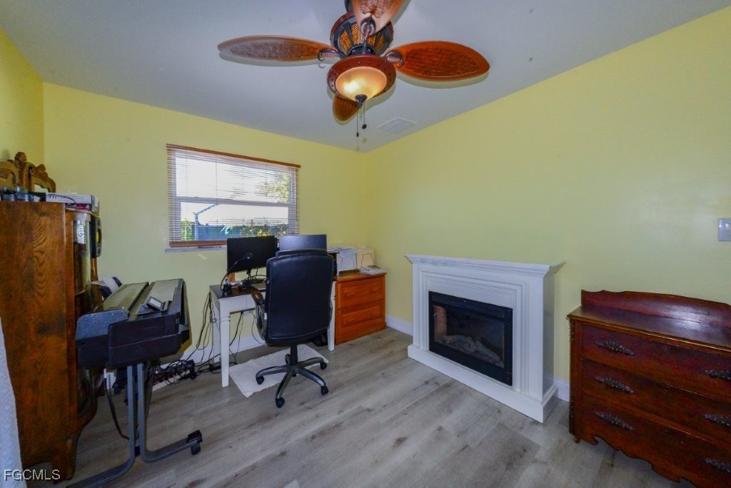 12082 Moon Shell Drive Matlacha Isles, FL 33991 - Photo 27 of 46 a workspace with furniture and a fireplace