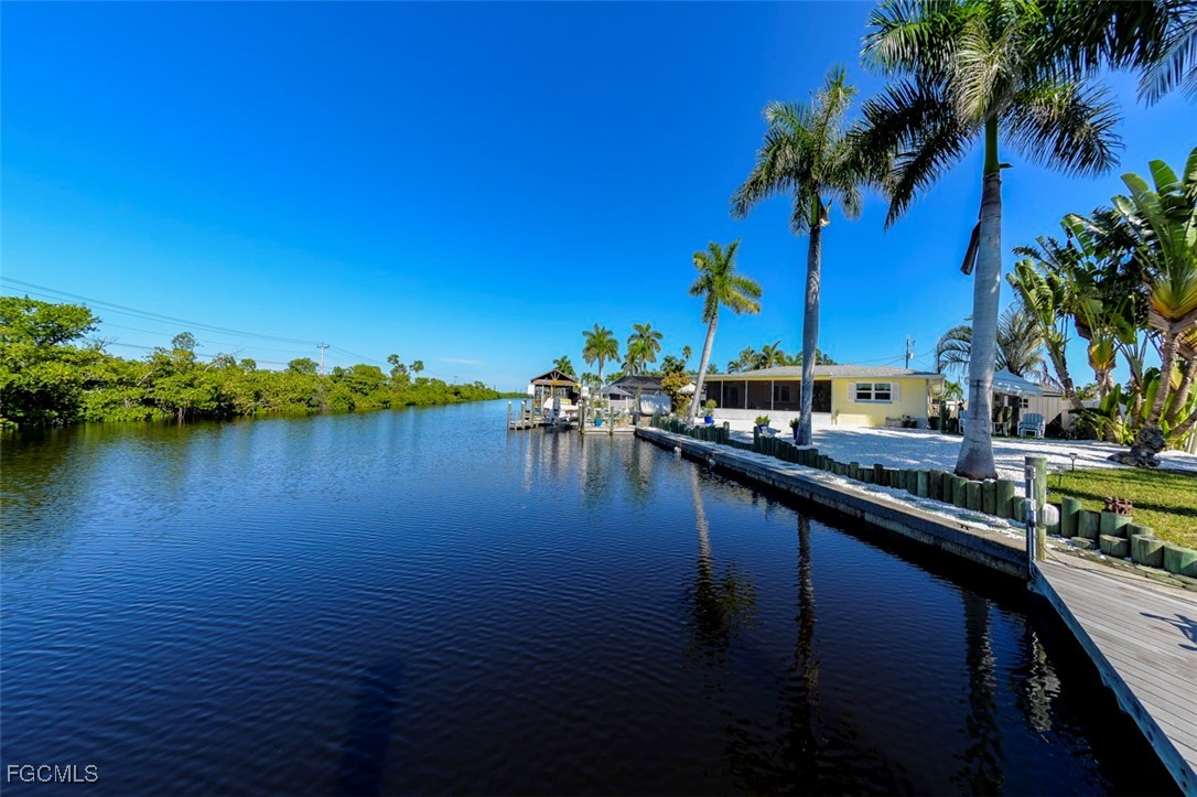 12082 Moon Shell Drive Matlacha Isles, FL 33991 - Photo 30 of 46 a lake view with boat and palm trees