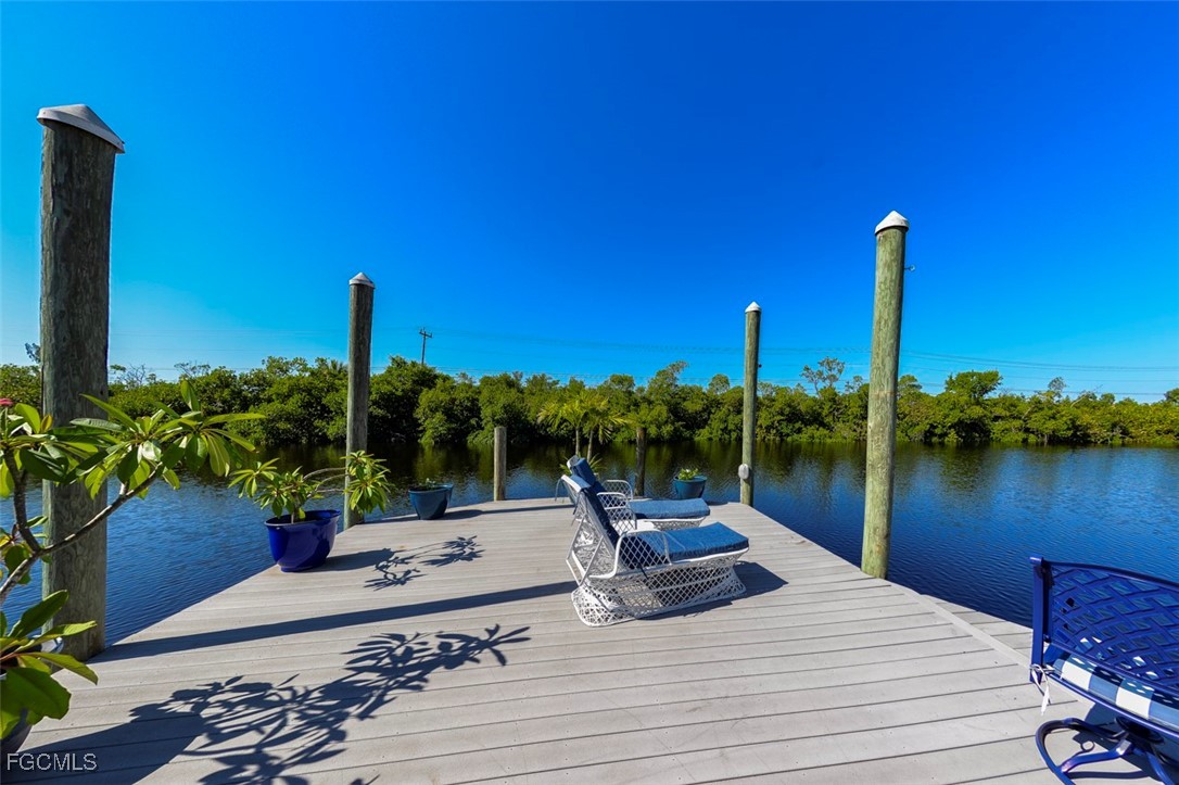 12082 Moon Shell Drive Matlacha Isles, FL 33991 - Photo 31 of 46 a view of a lake with a table and chairs